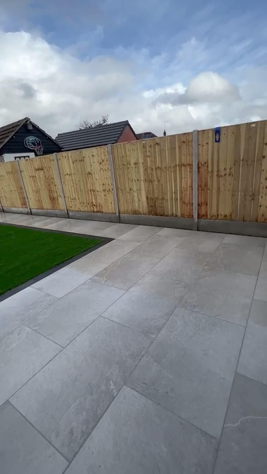 Walkthrough of new close-board fencing with concrete posts around a freshly paved garden